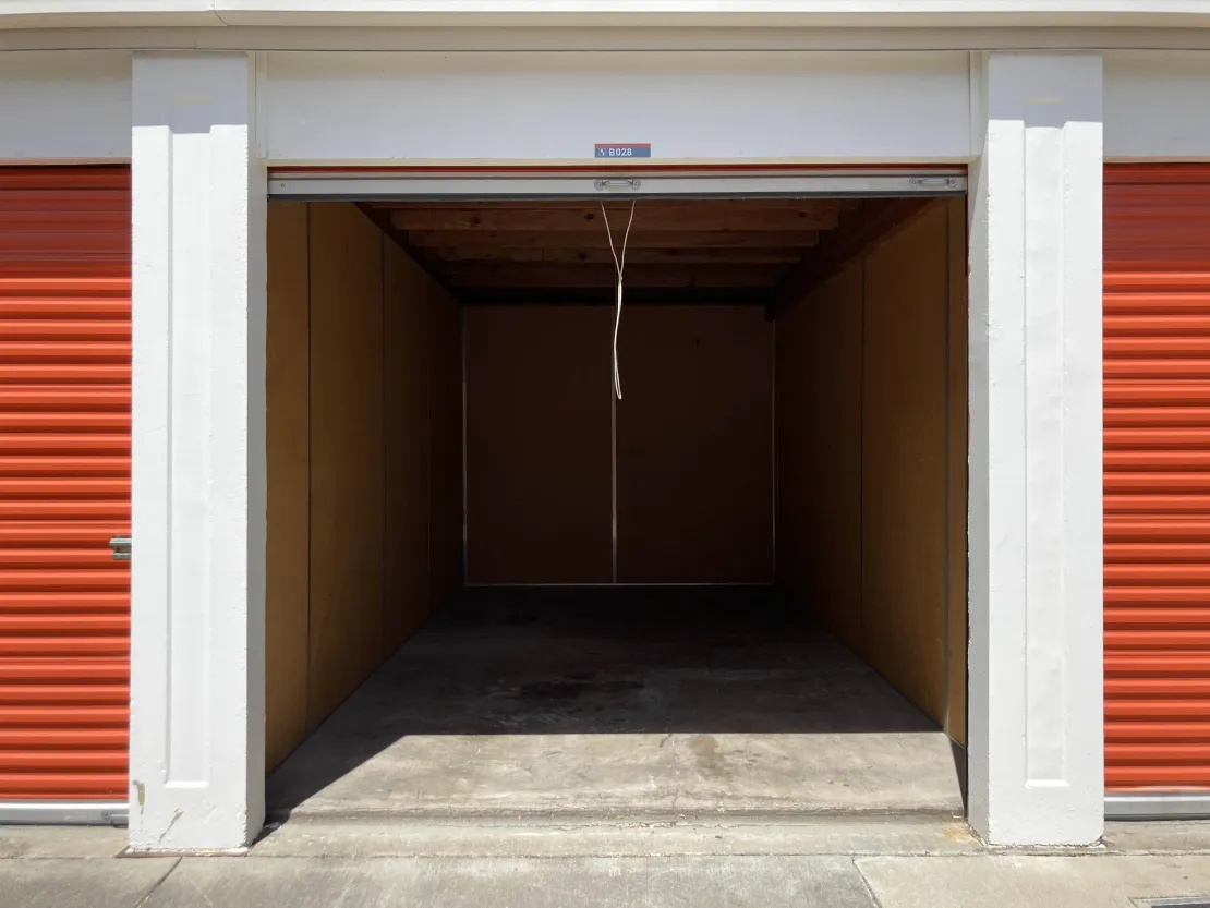 Empty self-storage unit with the roll-up door open